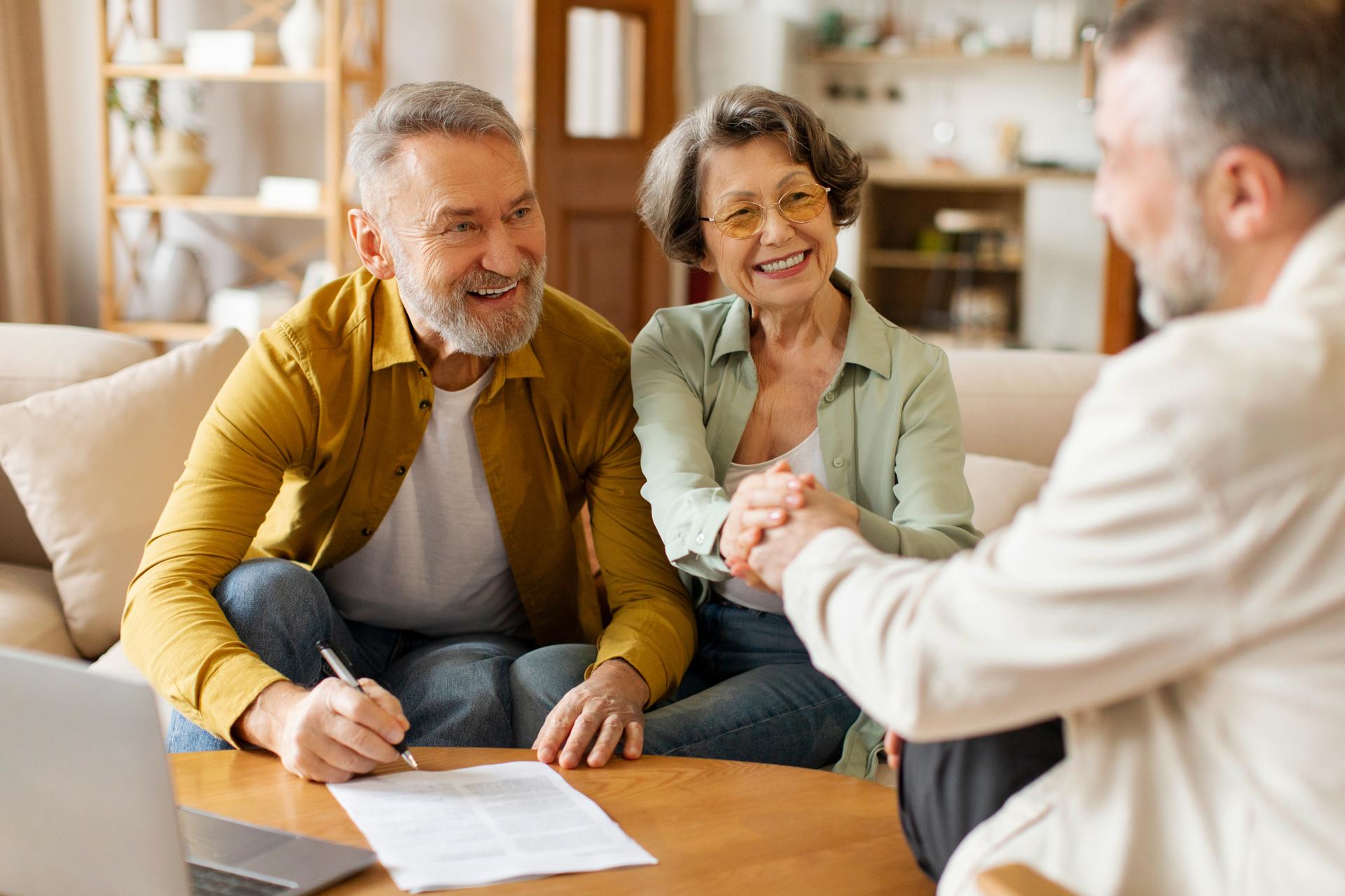 Insurance agent shaking hands with a client after a policy review